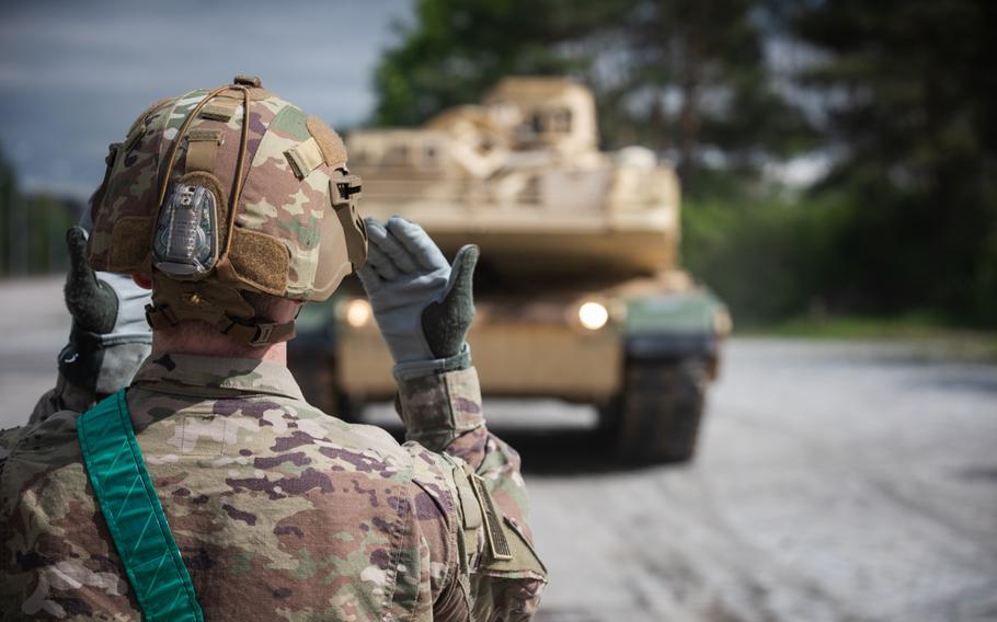 A U.S. soldier directs the delivery of M1A1 Abrams tanks used to train Ukrainian forces at Grafenwoehr, Germany, on May 12, 2023. The M1A1 training was expected to last 12 weeks but was recently extended.