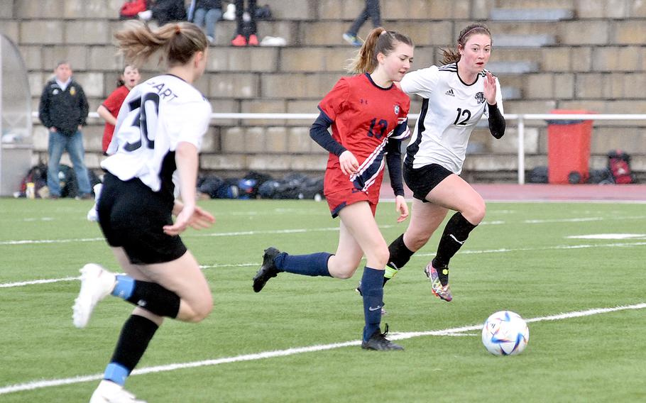 Lakenheath's Heidi Amberson dribbles toward goal as Stuttgart's Anna Thompson chases during Friday evening's match at Kaiserslautern High School in Kaiserslautern, Germany. Amberson scored a goal during the Lancers' 2-1 victory over the Panthers.