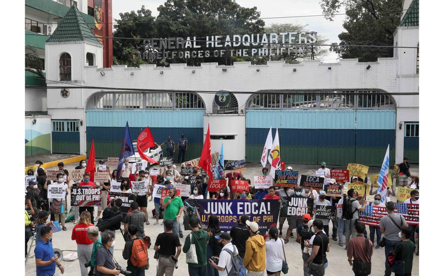 A few dozen leftist activists held a noisy protest Thursday, Feb. 2, 2023, and set fire to a mock U.S. flag outside the main military camp where Defense Secretary Lloyd Austin held talks with his Philippine counterpart.