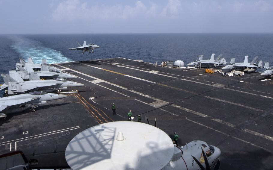 An F/A-18F Super Hornet lands on the aircraft carrier USS Nimitz in the Persian Gulf in October 2020. Nearly half of Americans polled recently by the Eurasia Group Foundation think U.S. military activities abroad should be reduced. 