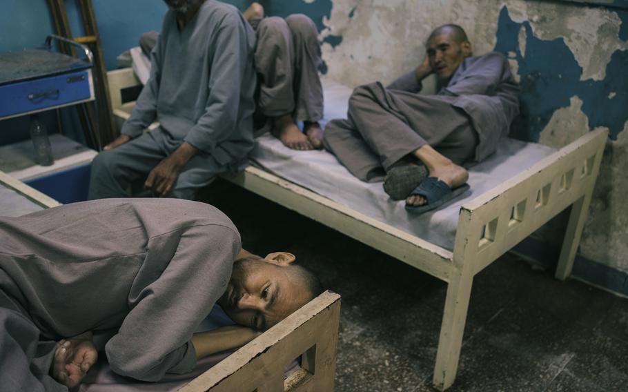 Patients of the rehabilitation center for drug addicts in Kabul lay on beds in their first period of detoxification.