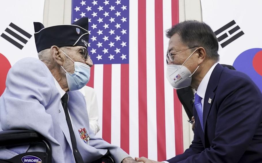 South Korean President Moon Jae-in greets retired Army Col. William Weber during the groundbreaking for the Korean War Veterans Memorial Wall of Remembrance in Washington, D.C., May 21, 2021.