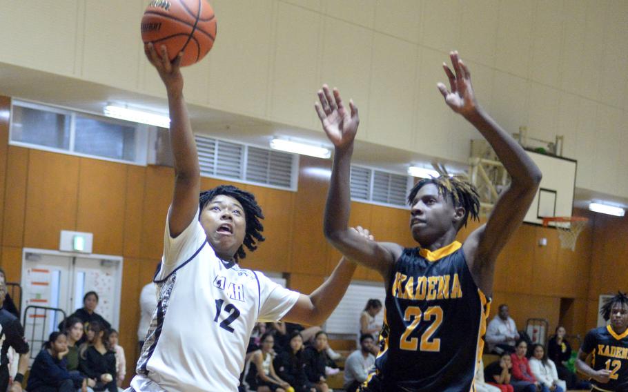 Zama’s Casey Stewart drives to the basket against Kadena’s Jayden Allen. The Panthers beat the Trojans 43-32.