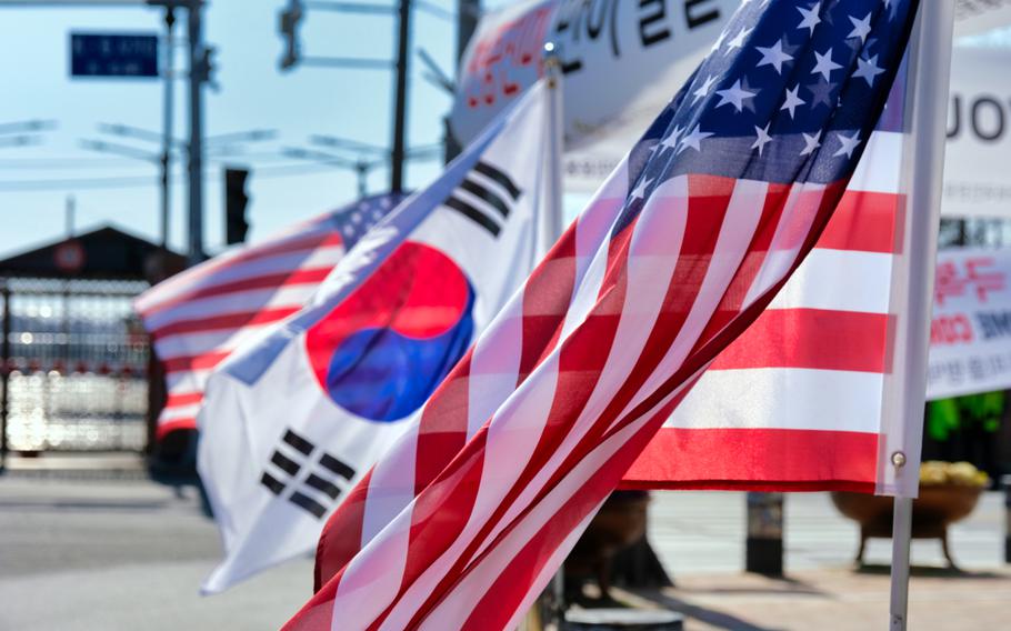 The flags of the United States and South Korea fly side by side outside Camp Humphreys, South Korea, March 16, 2020.
