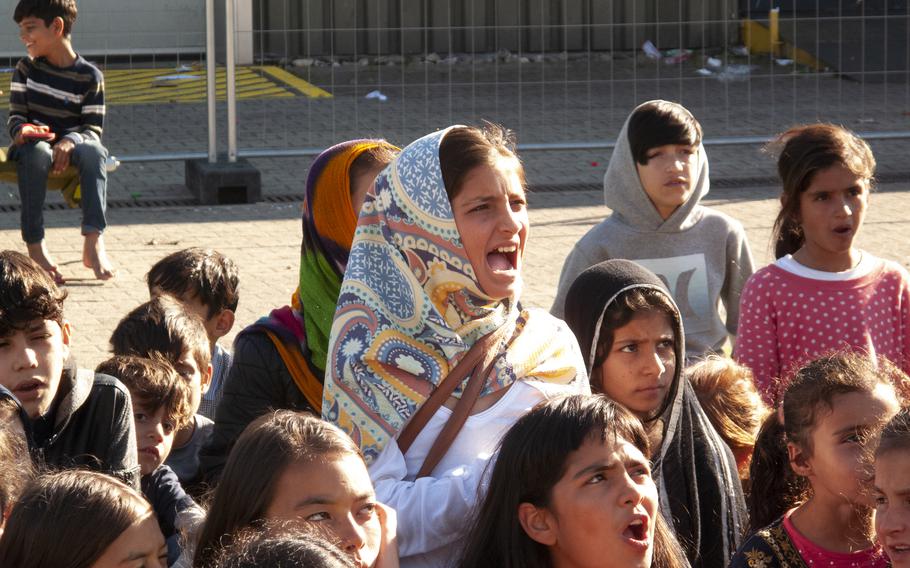 Afghan children take part in an English class led by volunteer teacher Morgan Guinn at Rhine Ordnance Barracks in Kaiserslautern, Germany, Sept. 23, 2021.