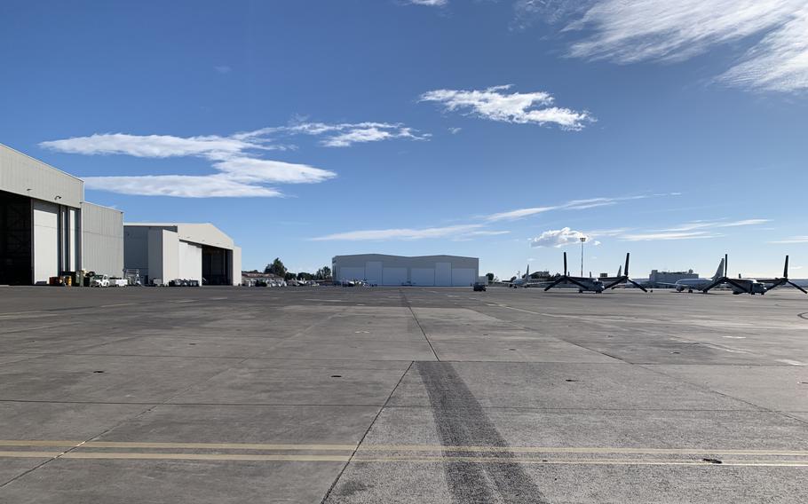 A new $26.5 million P-8 Poseidon hangar at Naval Air Station Sigonella in Sicily, Italy, seen in the background on Feb. 2, 2022, can hold two of the aircraft simultaneously. Previously, P-8 maintenance took place in a smaller hangar designed for P-3 Orion aircraft. 
