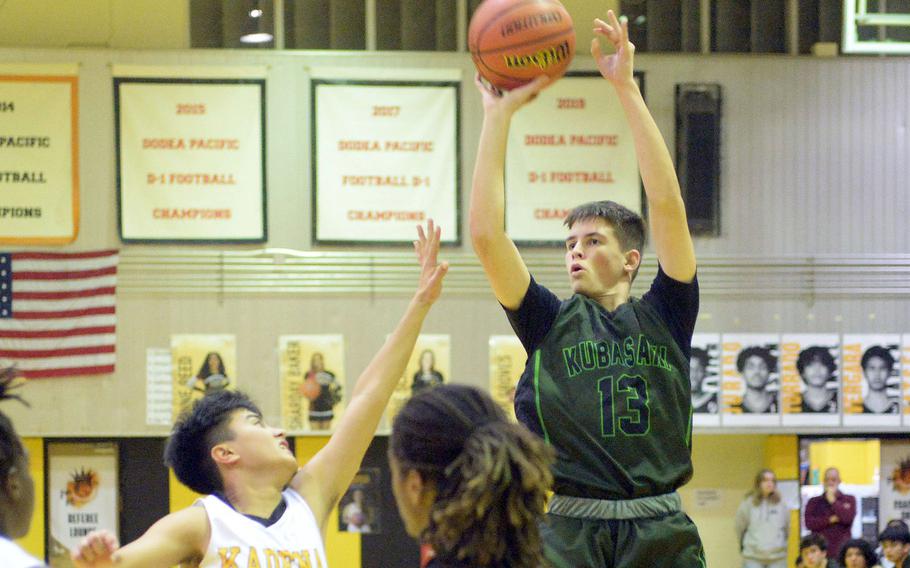 Kubasaki's Lucus Andrews shoots over Kadena's Jaden Patsel during Friday's Okinawa boys basketball game. The Panthers won 49-44, completing a four-game season-series sweep of the Dragons.