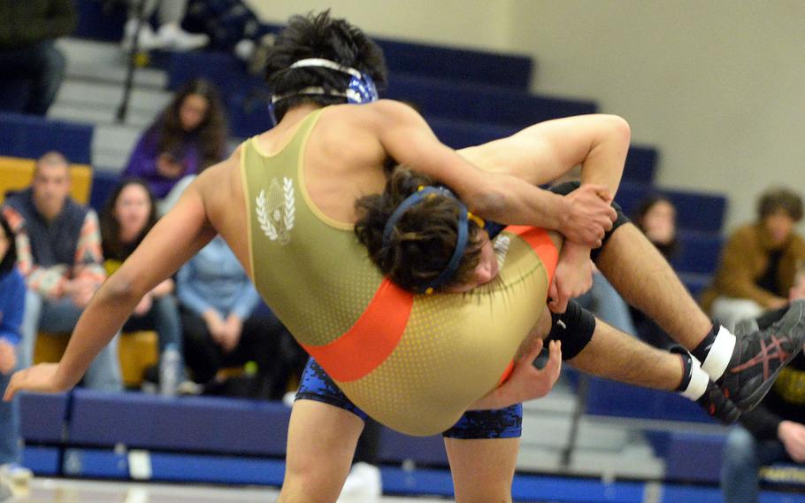 Yokota 152-pounder Aiden Greer lifts St. Mary's Kaliban Baskaran during Wednesday's Kanto Plain dual meet. Baskaran shook off the move to win by technical fall 12-2 in 2 minutes, 39 seconds, and the Titans won the meet 40-18.