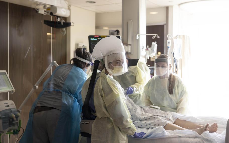 A team of nurses and physicians transfers a patient with COVID-19 into the intensive care unit at St. Cloud Hospital in Minnesota in November 2021. 