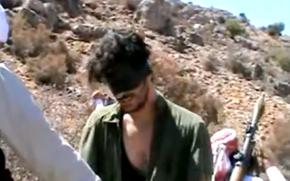 FILE - In this image taken from undated video posted to YouTube, American freelance journalist Austin Tice, who had been reporting for American news organizations in Syria until his disappearance in August 2012, prays in Arabic and English while blindfolded in the presence of gunmen. President Joe Biden says Washington is certain that the Syrian government is holding American journalist Austin Tice who went missing in the war-torn country a decade ago urging Damascus to help bring him back home. Biden’s comments were released in a statement Wednesday, Aug. 10, 2022, by the White House to mark the 10th anniversary since Tice was abducted.  (AP Photo, File)