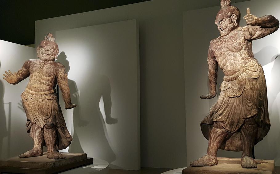Twelth century gate guardian statues stand inside Tokyo National Museum, which is celebrating its 150th anniversary.