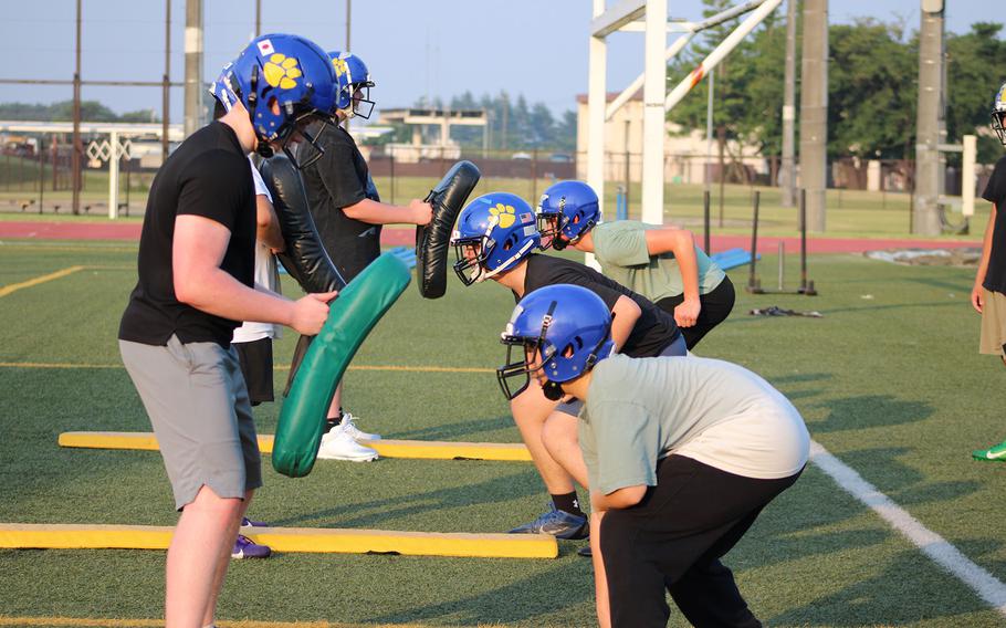 Yokota players practice blocking.