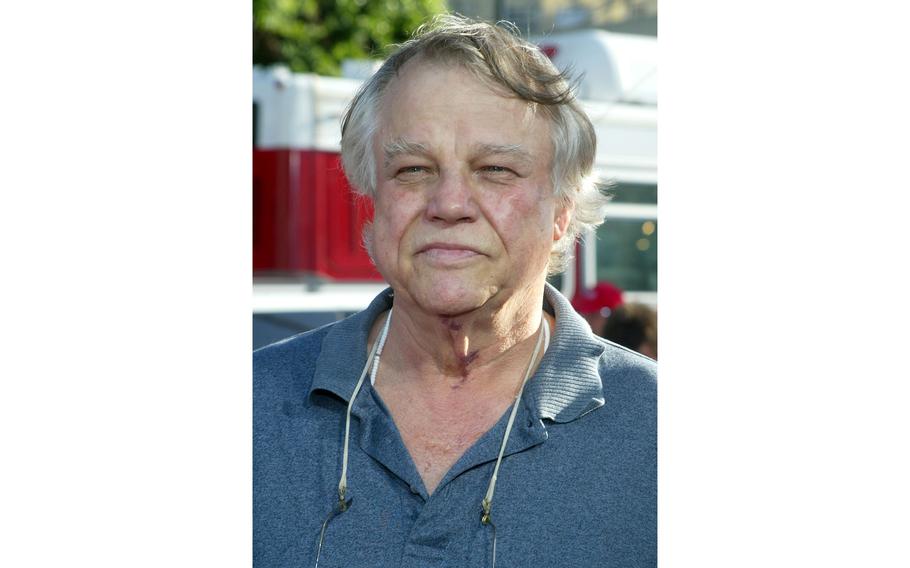 A vertical image of Joe Don Baker from the shoulders up, wearing a blue polo.