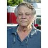 A vertical image of Joe Don Baker from the shoulders up, wearing a blue polo.