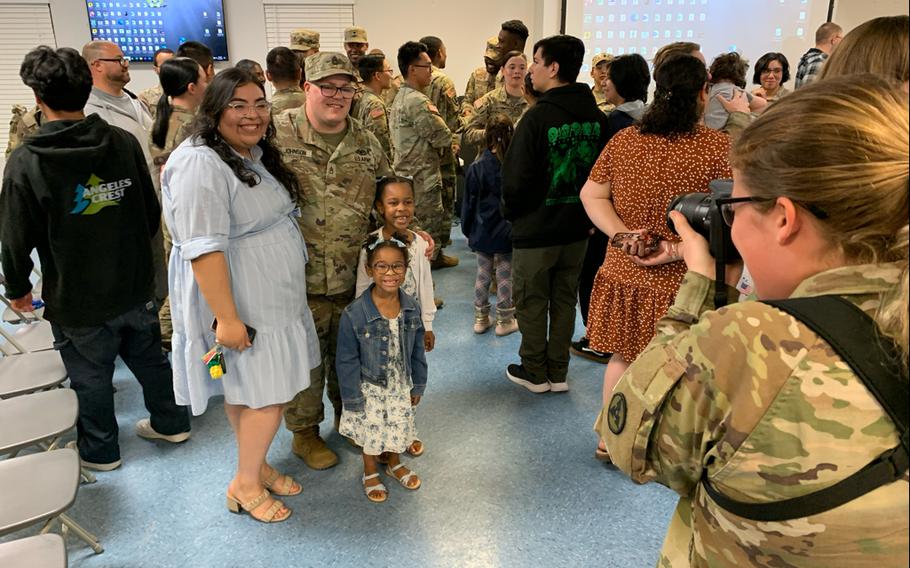 Staff Sgt. Calan Johnson, center, poses for a photo with his wife, Ashley, and their children during a welcome home ceremony for the 54th Quartermaster Company on April 12, 2024, at the Family Life Center on Fort Gregg-Adams, Va.