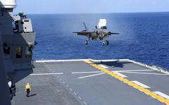 A Marine Corps F-35B Lightning II stealth fighter makes a vertical landing aboard the JS Izumo, a Japanese helicopter carrier, in the Philippine Sea, Sunday, Oct. 3, 2021. 