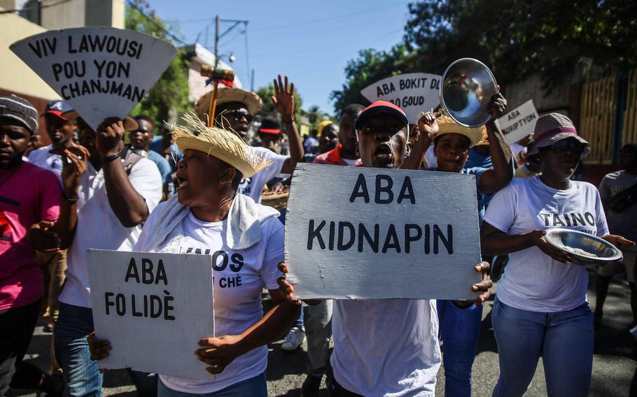 People protest in Port-au-Prince, Haiti on Nov. 18, 2021, against the country’s spike in kidnappings and gang-aggravated fuel crisis, on the day marking the 218th anniversary of the Battle of Vertières, the historic victory against France.