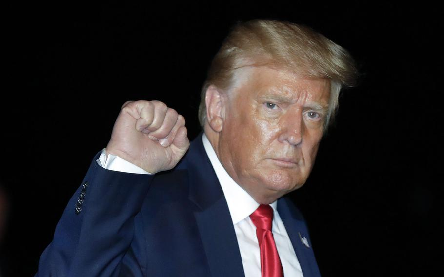 Then-President Donald Trump pumps his fist as he walks on the South Lawn of the White House in Washington, D.C., on July 31, 2020. 