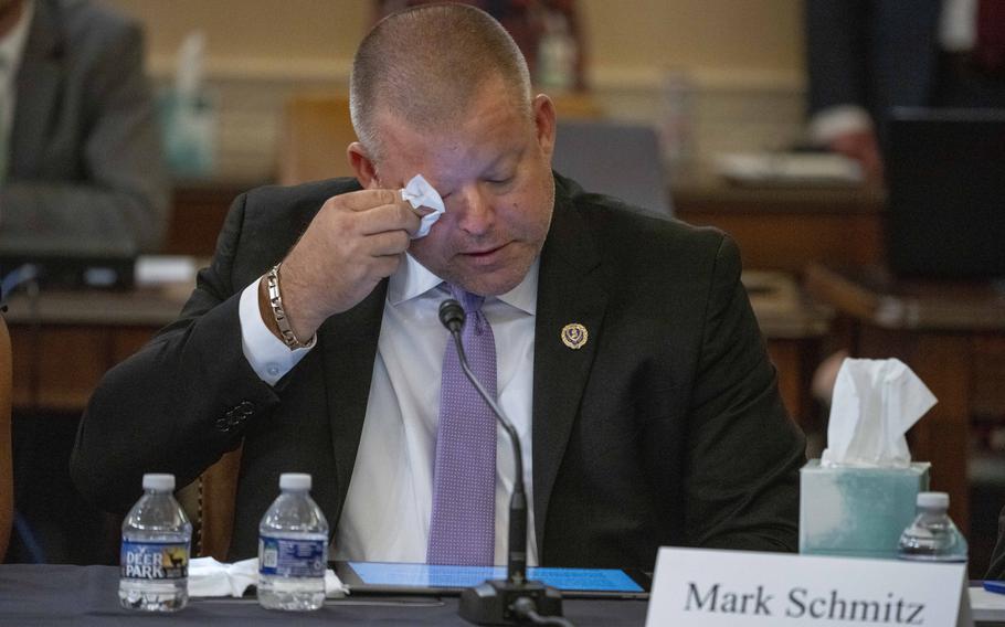 Mark Schmitz, father of Marine Corps Lance Cpl. Jared Schmitz and an Abbey Gate Gold Star family member, wipes a tear as he speaks Tuesday, Aug. 29, 2023, at a House Foreign Affairs Committee roundtable discussion on Capitol Hill in Washington. 