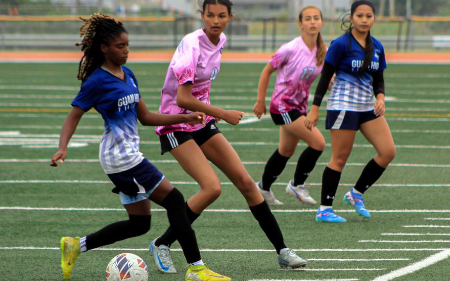 Guam High's Ny'Kale Penn and Kadena's Rylie Gilliland battle for the ball.