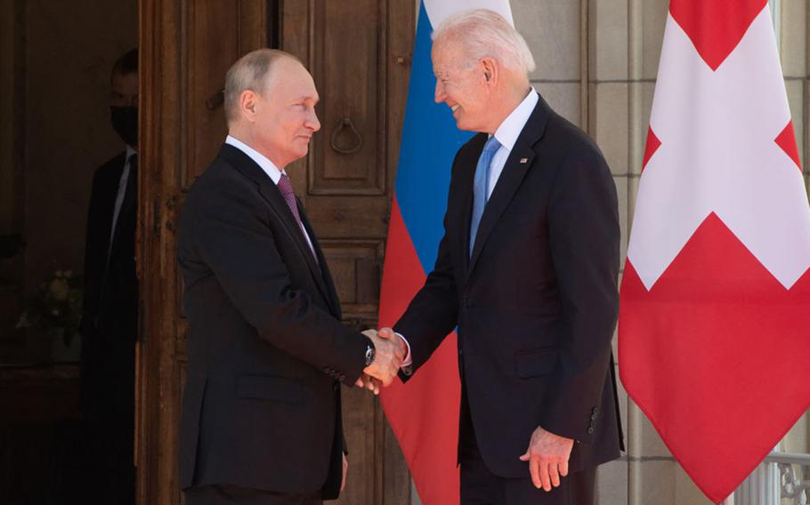 President Joe Biden (right) and Russian President Vladimir Putin shake hands as they arrive for a US-Russia summit at Villa La Grange in Geneva on June 16, 2021.