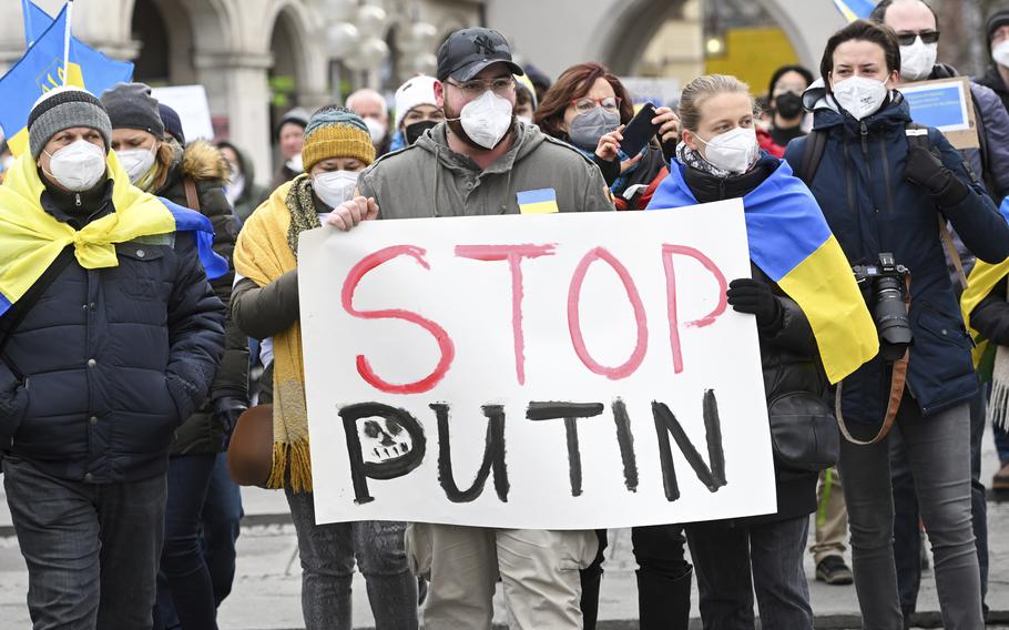 Protesters hold a placard reading “Stop Putin” during a demonstration at Odeonsplatz against Russia’s attack on Ukraine, Munich, Germany, Saturday, Feb. 26, 2022.