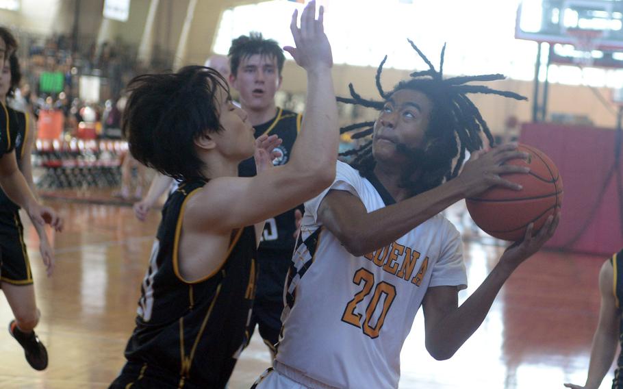 Kadena's Jayden Allen tries to shoot against American School In Japan during Saturday's Okinawa-American Friendship Tournament pool-play game. The Panthers won 60-47.