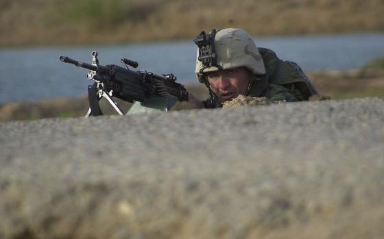 Hed: Covering a raid, 2003

Al Fahr, Iraq, Mar. 29, 2003: A Marine sqaud automatic machine gunner takes cover behind a drop-off on the edge of a road during a raid at Al Fahr, Iraq.  Company G, 2nd Battalion, 23rd Marines would end the day dismanteling what appeared to be a military training school and taking in 19 detainees, three of whom turned out to be Baath officials, and confiscating two long-range bolt-action rifles, 20 AK-47 and AK-74 rifles, one mortar tube, two machine guns, 10 crates of grenades, five crates of ammunition and stacks of documents.

Read more at: https://www.stripes.com/history/2023-05-16/raid-on-al-fahr:-marines-find-weapons,-baath-officials,-intelligence-data-1519661.html
           


META TAGS: Operation Iraqi Freedom; Iraq; USMC; U.S. Marine Corps; Marines; 
