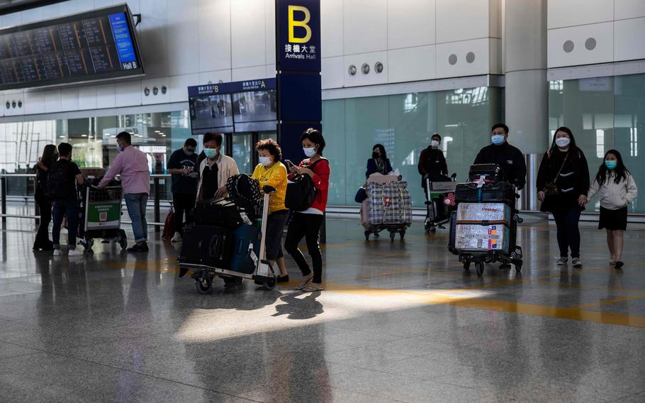 Passengers arrive at Hong Kong International Airport in December.