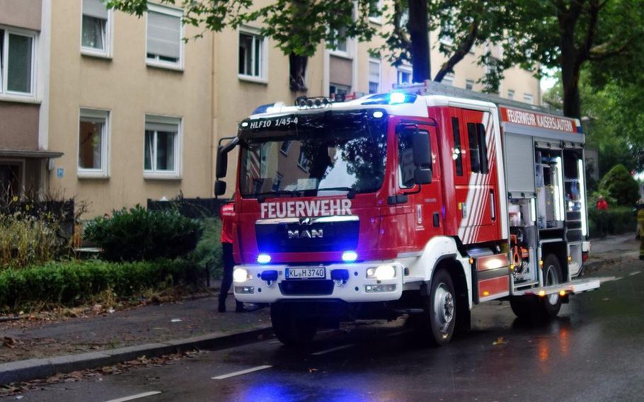 A firetruck is parked on a city street in Germany.