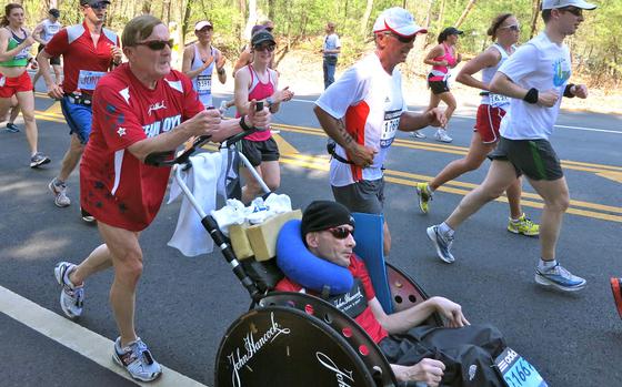Dick Hoyt, left, pushes his son, Rick Hoyt, during a race on April 16, 2012. Over nearly four decades, Rick Hoyt and his father, Dick Hoyt, became celebrated fixtures of the Boston Marathon. 