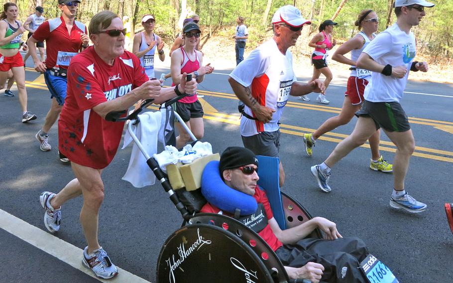 Dick Hoyt, left, pushes his son, Rick Hoyt, during a race on April 16, 2012. Over nearly four decades, Rick Hoyt and his father became celebrated fixtures of the Boston Marathon. 