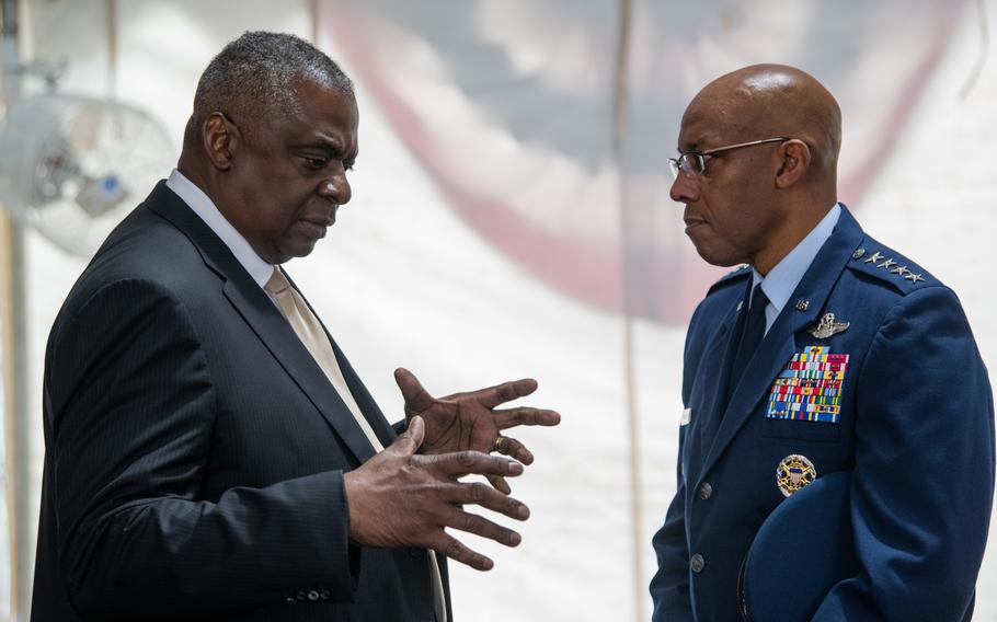 Defense Secretary Lloyd Austin speaks with Air Force Gen. CQ Brown, the new chairman of the Joints Chief of Staff, at Joint Base Myer Henderson Hall in Arlington, Va., on Sept. 29, 2023.