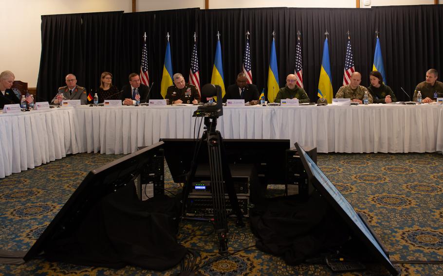 International defense officials listen to a video message from Ukrainian President Volodymyr Zelenskyy during the Ukraine Defense Contact Group meeting on Friday, Jan. 20, 2023, at Ramstein Air Base, Germany.