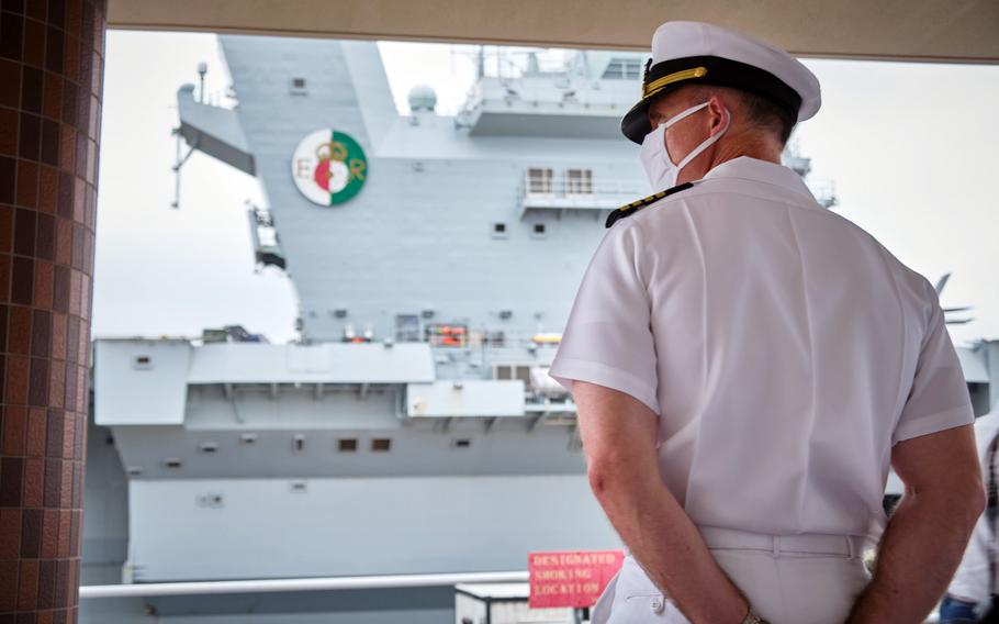 Installation commander Capt. Rich Jarrett watches the HMS Queen Elizabeth steam into Yokosuka Naval Base, Japan, Saturday, Sept. 4, 2021. 