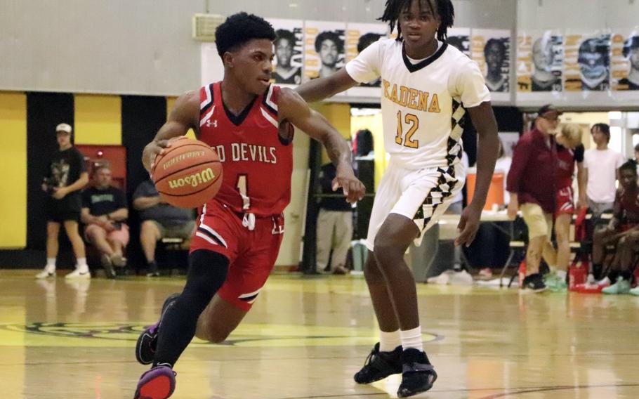 Kinnick's Xavier Wright drives against Kadena's DeShaun Nixon.