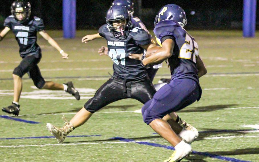 Guam High's Deshaun Baird looks for running room against Southern's Bobby Taisipic.