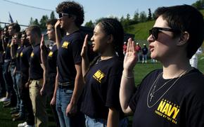 Future U.S. Navy sailors recite the oath of enlistment during a ceremony in Eagle River, Alaska, June 19, 2025. The Navy did not properly document how it turned around sluggish recruitment in 2024, according to a Defense Department Inspector General report dated June 27, 2025.