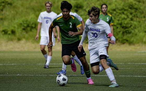 Sigonella's Mikolaj Czernielewski pushes past Alconbury’s Taye Vickerstaff during a game at the DODEA-Europe soccer finals in Landstuhl, Germany, in May 2024. All DODEA athletic events in Europe have been postponed this weekend due to executive orders pausing non-mission essential travel and government travel card use, agency officials announced March 12, 2025.