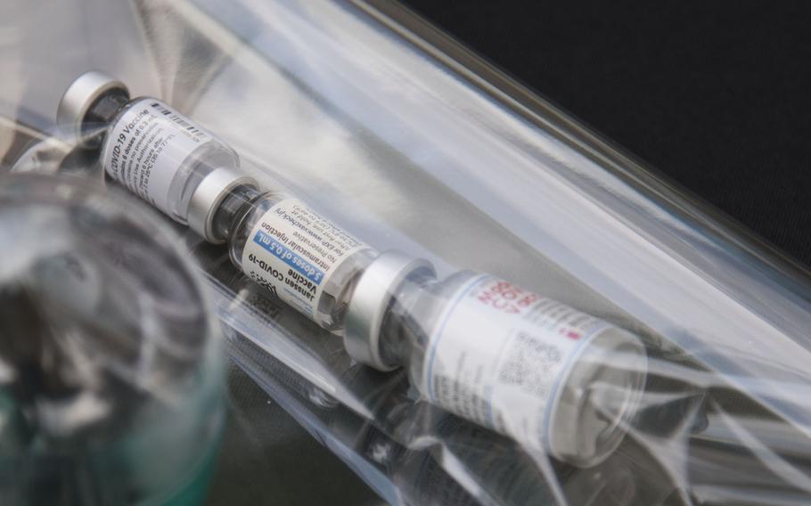 COVID-19 vaccine vials are placed inside a time capsule at Yokota Air Base, Japan, Thursday.