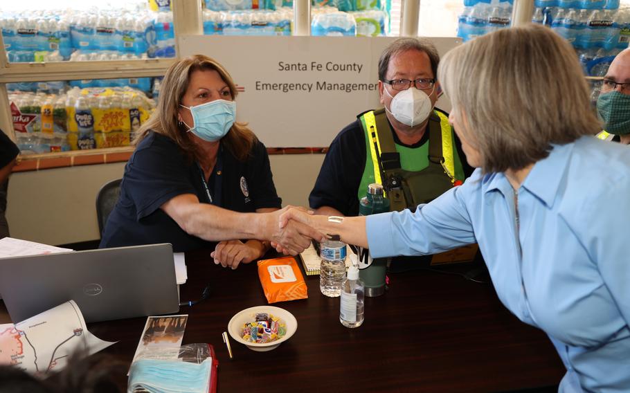 New Mexico Governor Michelle Lynn Lujan Grisham greets FEMA staff at a speaking and disaster survivor assistance registration event following New Mexico wildfires. Gov. Michelle Lujan Grisham on Monday appointed a former U.S. Navy officer to run the state agency tasked with responding to natural disasters.