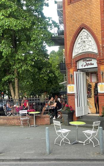 Patrons of Mama of Africa in Wiesbaden, Germany, enjoy a meal in the outdoor patio May 14, 2022. The restaurant specializes in cuisine from the Horn of Africa.