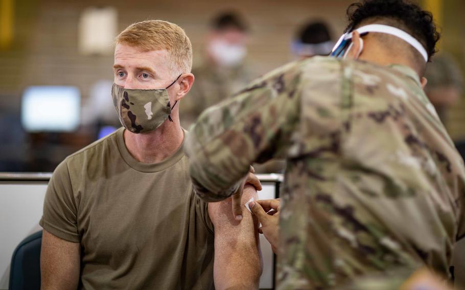 Army Col. Joshua Bookout receives the coronavirus vaccine at the Conroy Bowl on Schofield Barracks, Hawaii, in January 2021. 