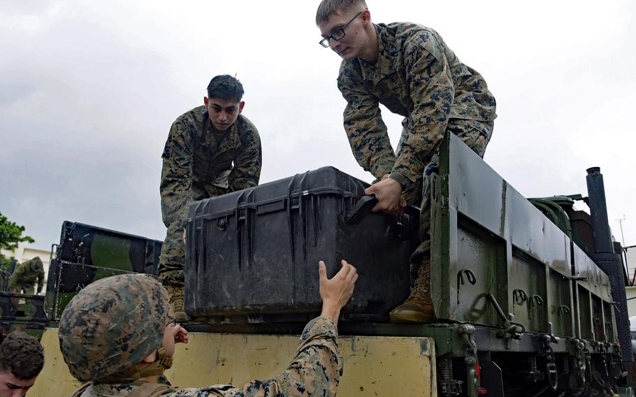 Marines unload a tactical vehicle at Kadena Air Base, Okinawa, Feb. 14, 2023, during jungle warfare training. 