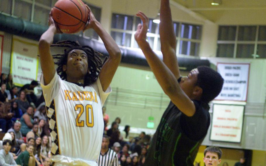 Kadena's Alexander Hye shoots against Kubasaki's Jordan Sellers during Friday's DODEA-Okinawa boys basketball game. The Panthers won 58-29, improving to 3-0 against the Dragons this season.