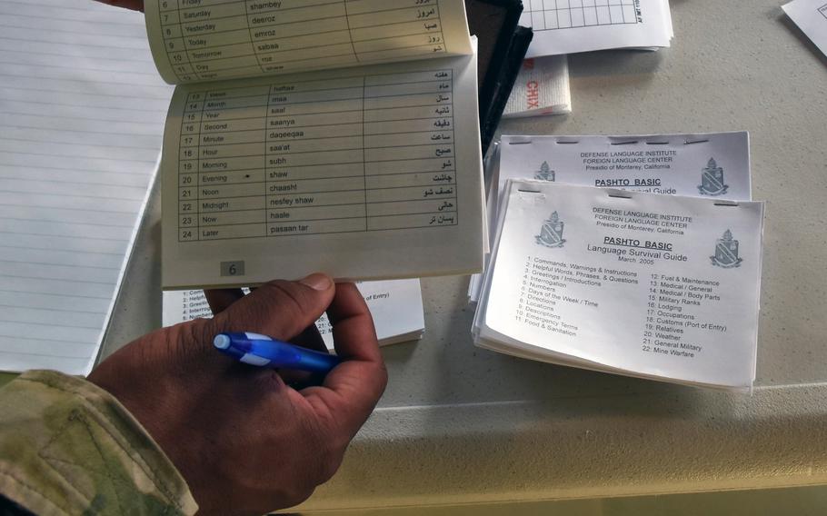 Pamphlets with common phrases in Pashto and Dari, two languages widely spoken in Afghanistan, are available to airmen working inside one of the tents set up to support Afghan evacuees at Ramstein Air Base, Germany, Aug. 21, 2021.