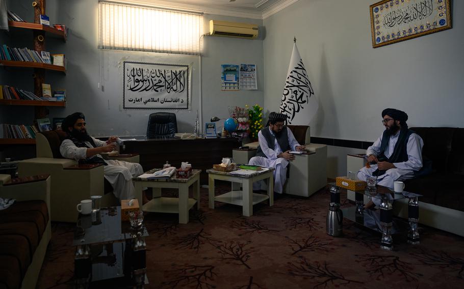 Taliban spokesman Inamullah Samangani, center, meets last month with other Taliban officials in his new office at the Department of Culture and Information in Kandahar in southern Afghanistan.