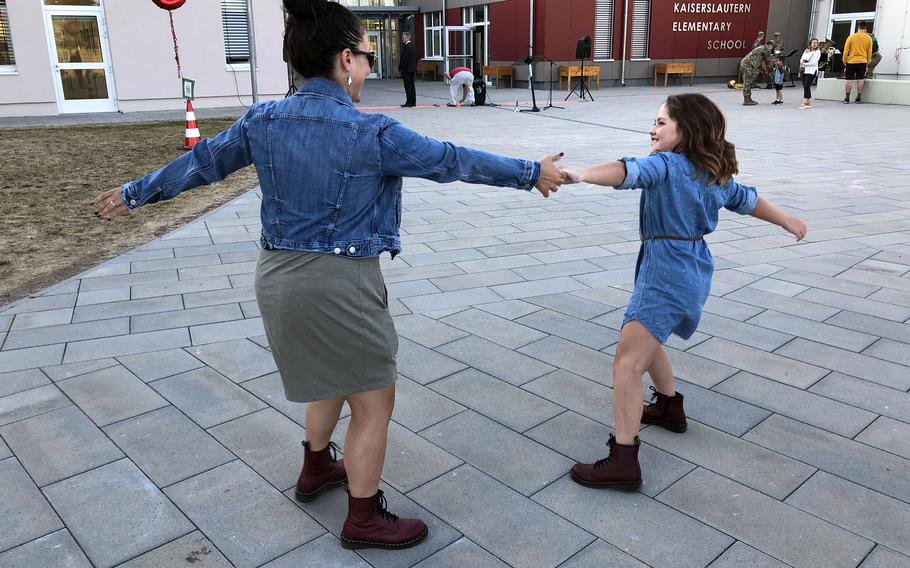 Air Force Master Sgt. Kassandra Maxcy dances with her daughter, Emily, a fourth grader at Kaiserslautern Elementary School, in Kaiserslautern, Germany, on the first day of school, Aug. 22, 2022.