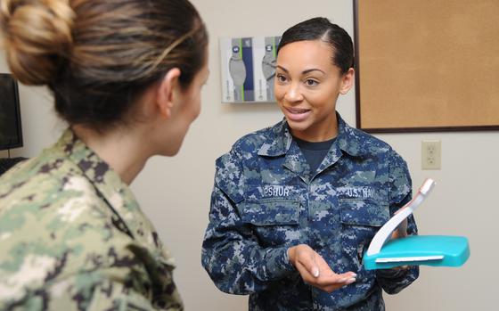 Seaman Sharay Upshur discusses intrauterine devices with a patient at a U.S. Naval Hospital Pensacola, Fla., clinic in 2018. The Navy in Naples recently opened the service's  second walk-in clinic in Europe that provides birth control to sailors.

Brannon Deugan/U.S. Navy