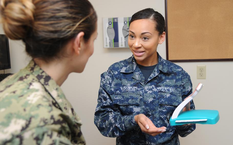 Seaman Sharay Upshur discusses intrauterine devices with a patient at a U.S. Naval Hospital Pensacola, Fla., clinic in 2018. The Navy in Naples recently opened the service's  second walk-in clinic in Europe that provides birth control to sailors.